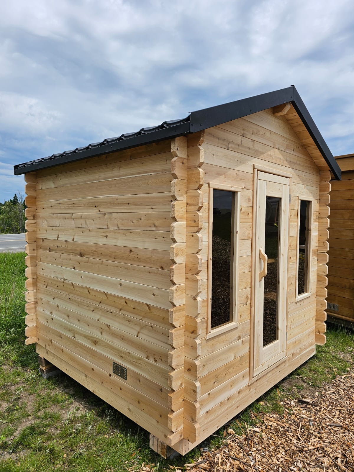 Cedar cabin sauna beside a lake
